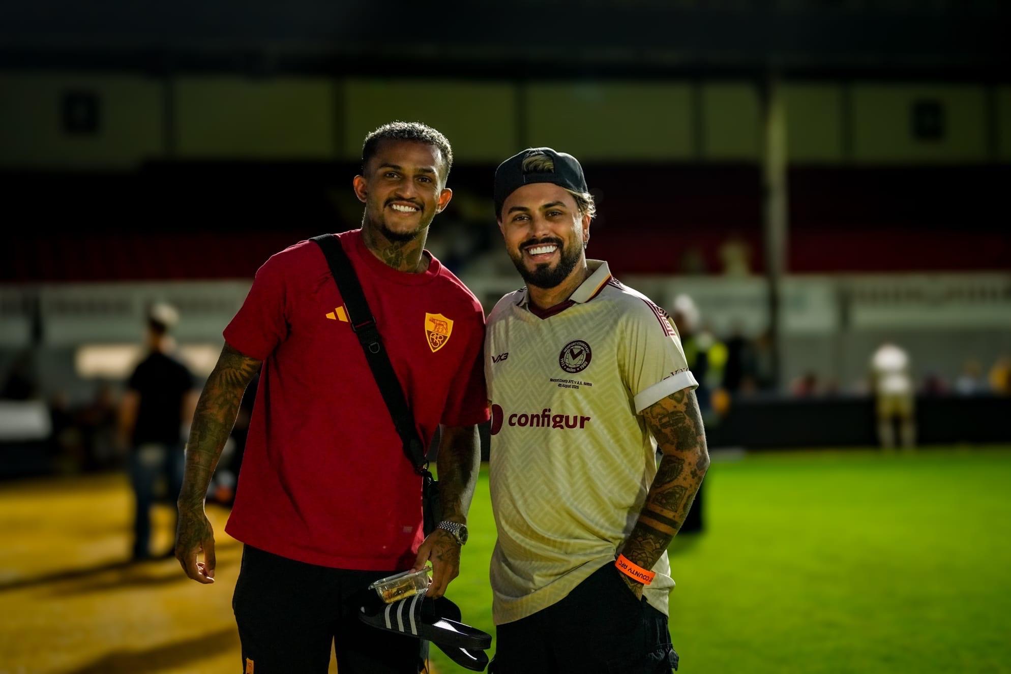 Gerryn Hussain with an AS Roma player on the pitch at full time