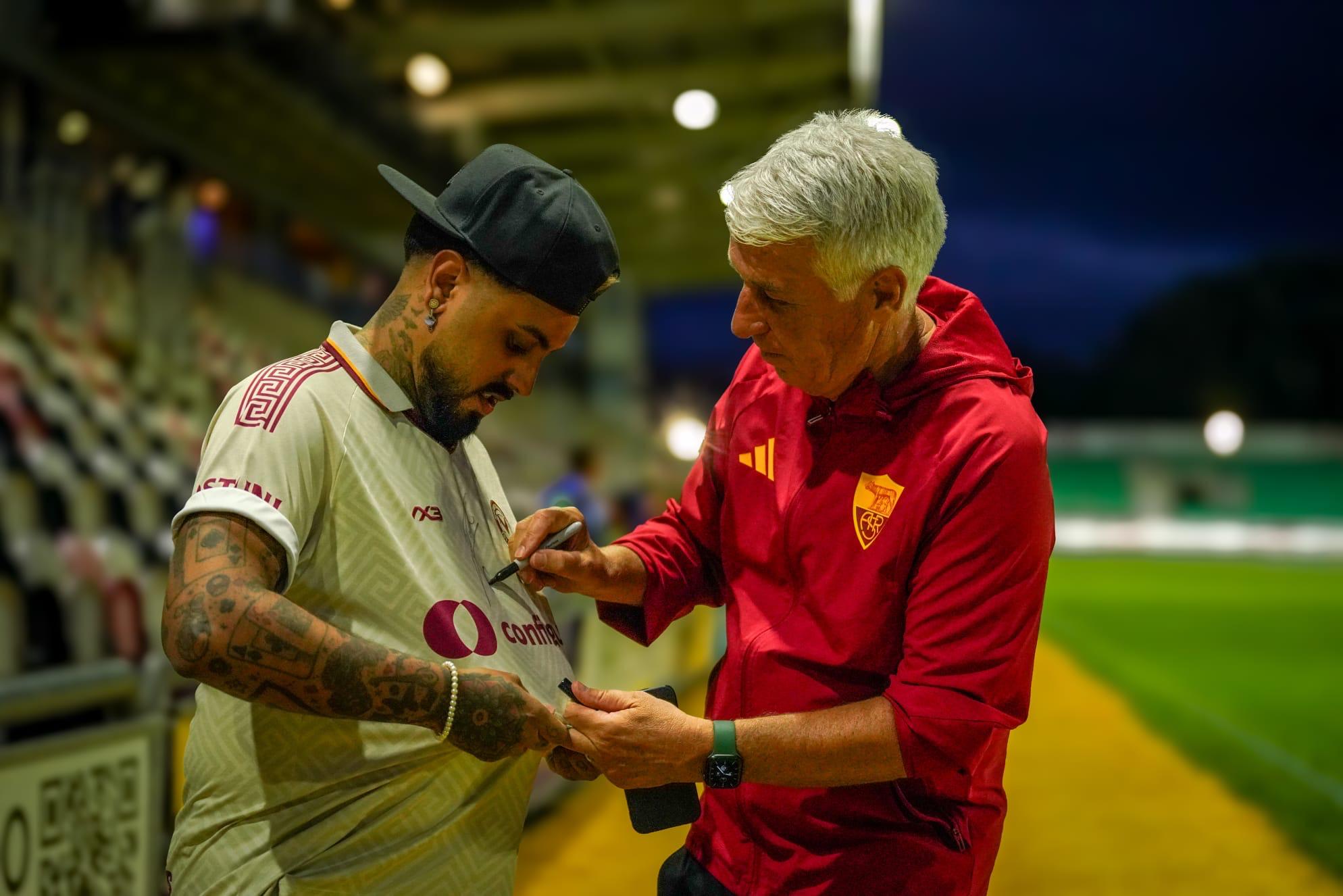 Gerryn Hussain having his Newport County shirt signed pitch-side